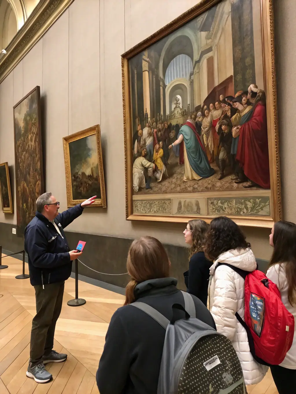 A photograph of a guided tour in a historical Breton museum, with a knowledgeable guide explaining artifacts to an engaged group of adults.